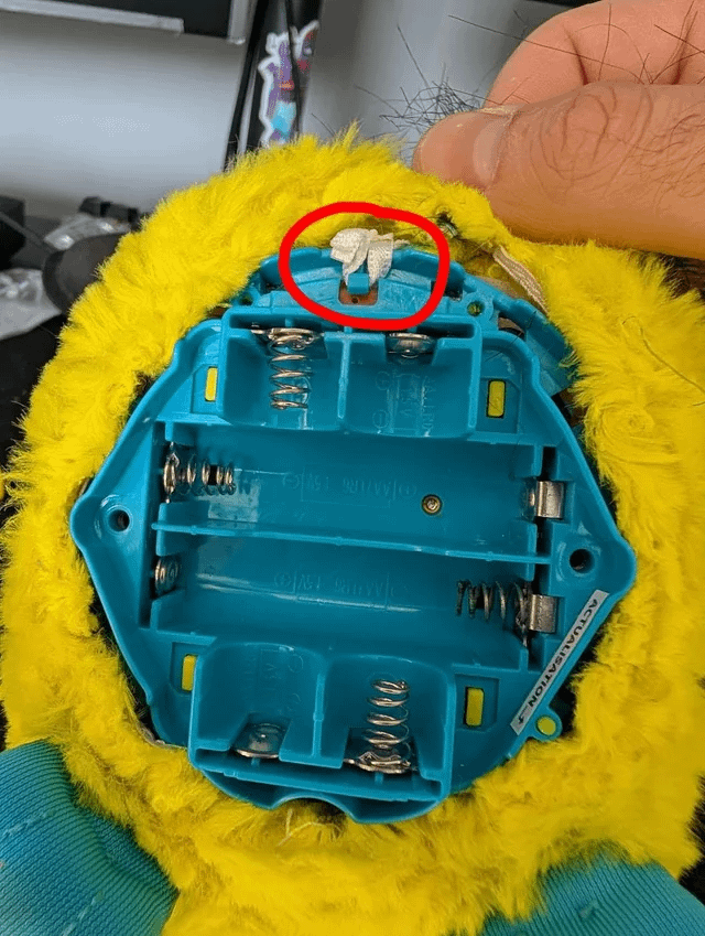 Furby tail hook exposed under the fur