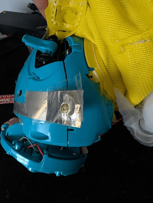 Foil touch sensor tape on the side of the Furby shell