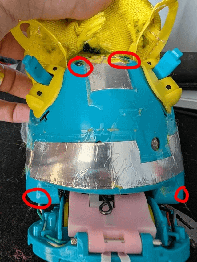 Four back shell screws marked on a Furby