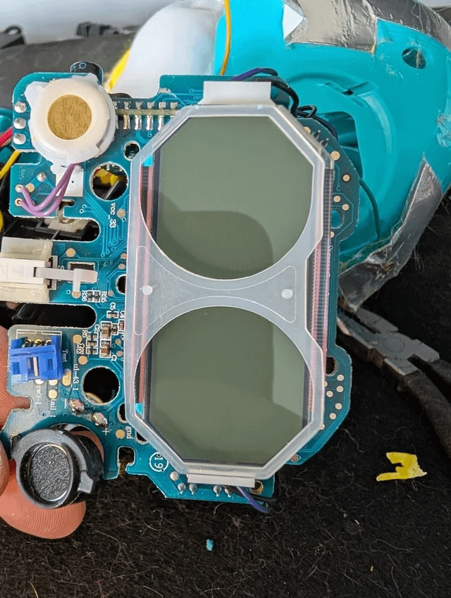 LCD glass and pink plastic strips marked for removal