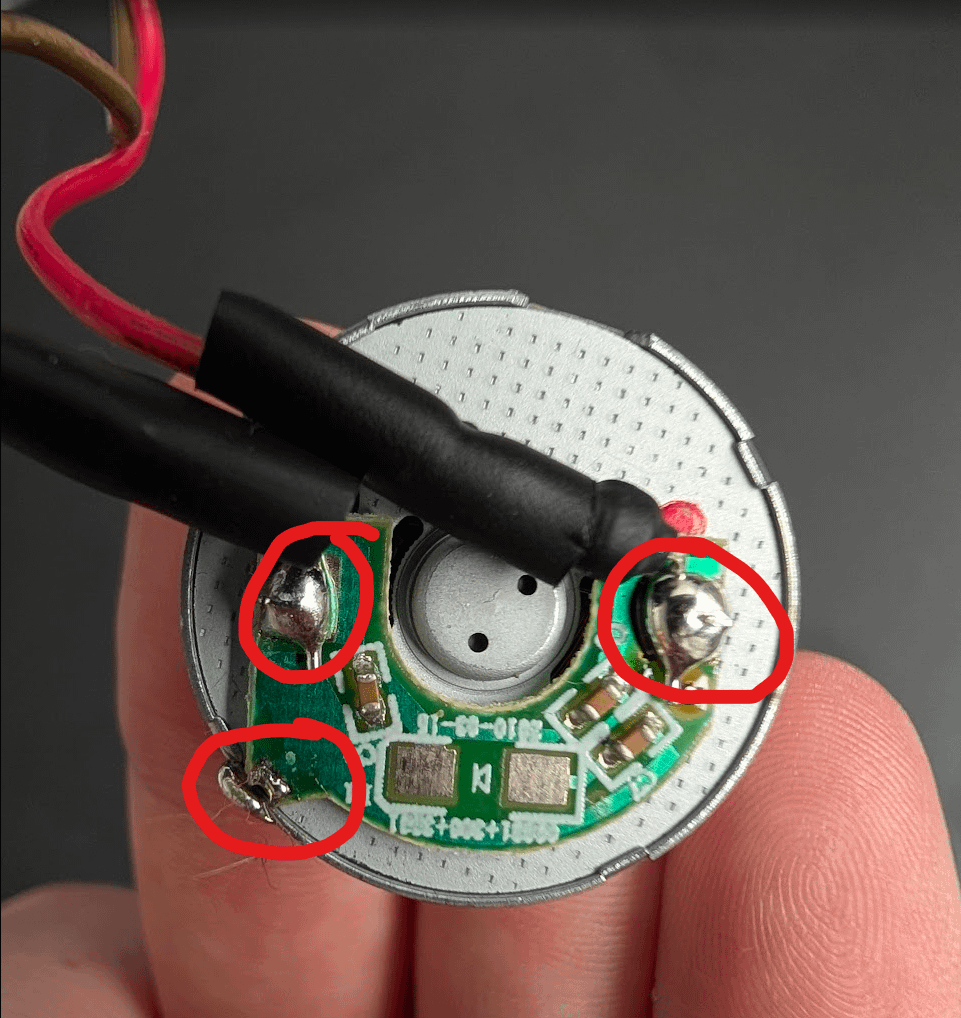 Three solder points marked on a Furby motor board