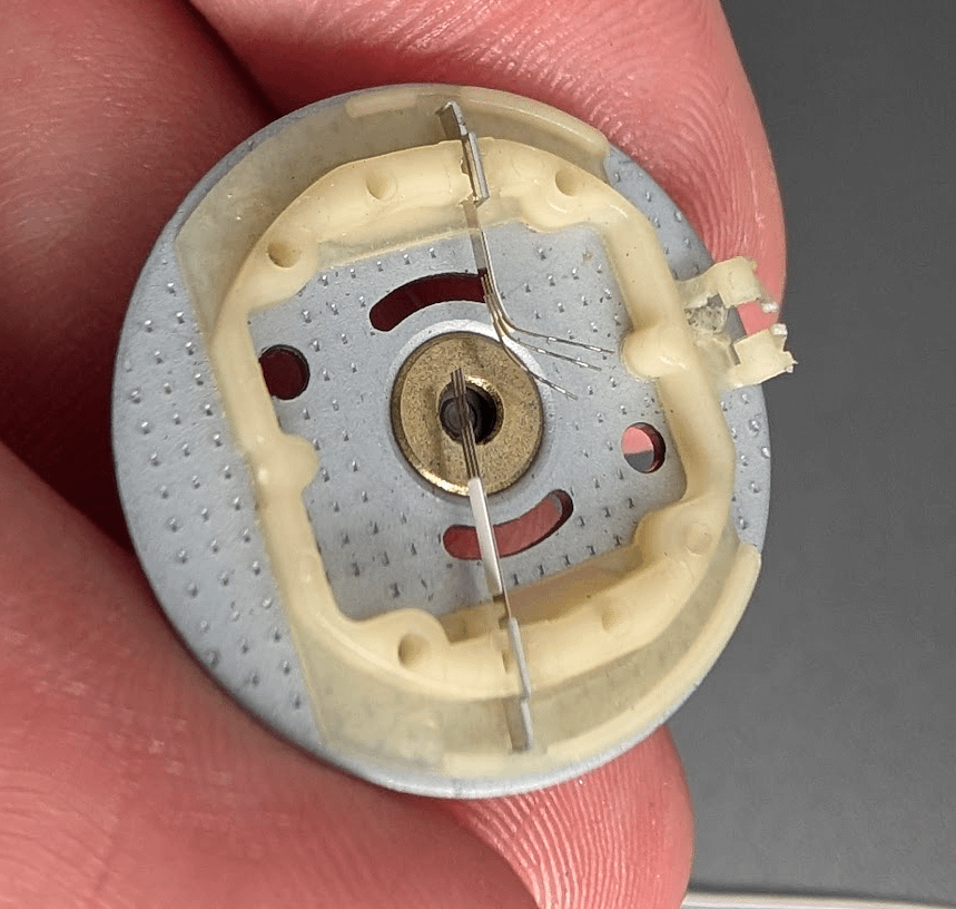 Burnt Furby motor brush bent to one side