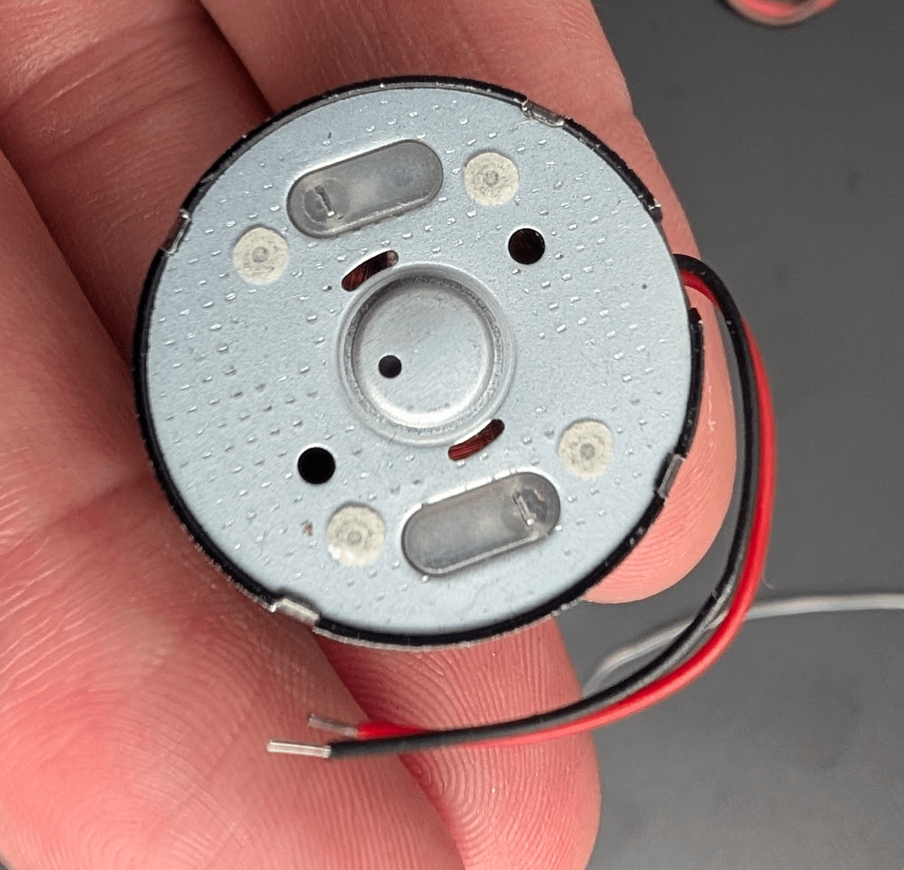Original Furby motor and black donor motor opened for comparison