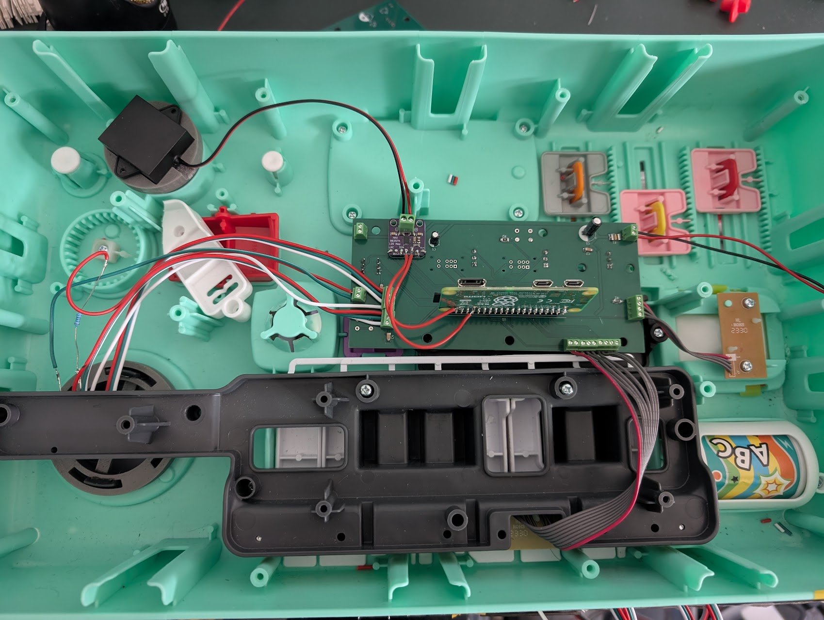 Custom carrier board and Raspberry Pi fitted inside the toy